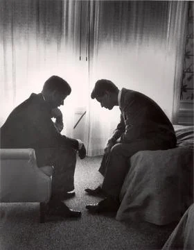 (L-R) Sen. John F. Kennedy conferring with his brother Robert F. Kennedy in hote Stock Photos