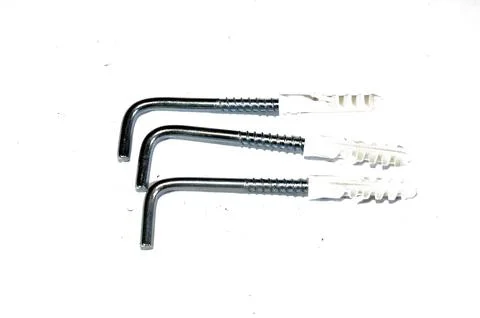 L-shaped screw hooks with plastic wall anchors, versatile fasteners for han.. Foto stock