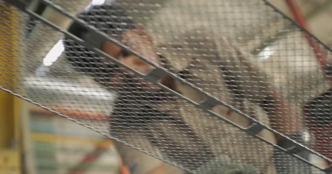 LA and Rack Focus Shot of Worker Examining Battery Lead Plates (4K) Stock Footage 60763074