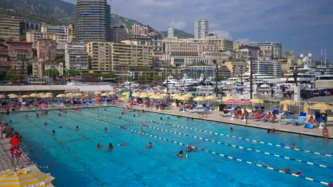 La Condamine, Monaco - August 25, 2024: View of people swimming in a pool at the Video stock 306366989