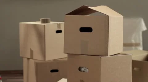 LA, CU, PAN of a man taping a box and writing Kitchen on it Stock Footage 10702614