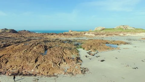 La Grosse Rocque beach Cobo Bay Guernsey.Panning across sandy beach and amazing Видео 336540162