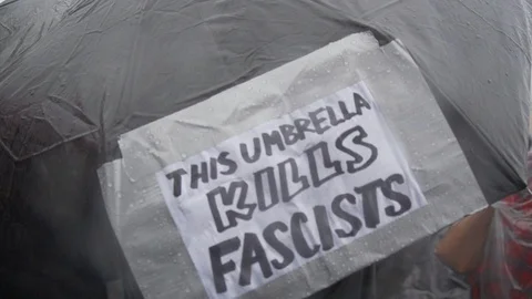 LA Package 7 | This Umbrella Kills Fascists Protest Sign Stock Footage 115137515