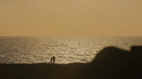 La Pared: engaged couple walking romantically on a deserted beach at sunset Vidéo 67493130