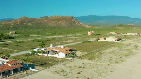 LA RIBERA BCS MEXICO-2020: Sand Fades Into Green Housing Plots With Mesa And Stock Footage 142540962
