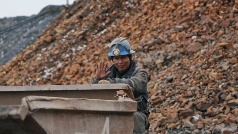 La Rinconada, Peru - March 5, 2026: Smiling Miner Waves at Camera From Mine Cart Stock Footage 345125294