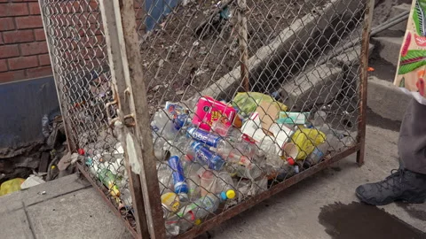La Rinconada, Peru - March 5, 2026: Person Disposing Waste Into Trash Container Stock Footage 345131556