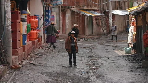 La Rinconada, Peru - March 5, 2026: Boy Walking Along Street in La Rinconada Stock Footage 345424114