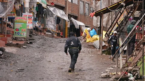 La Rinconada, Peru - March 5, 2026: Drunk Gold Miner Walking Muddy Street Stock Footage 346142226