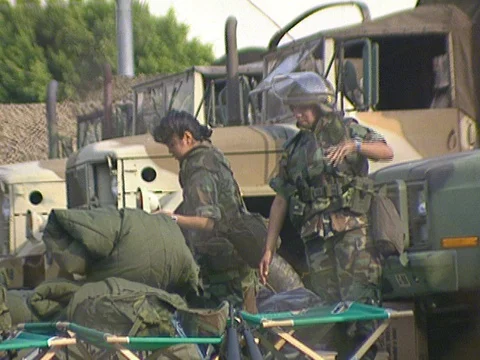 LA Riots 5-1-1992, Soldier waving in National Guard Base Camp in Downtown LA Stock Footage 78243224