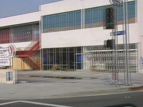 LA Riots 5-1-1992, Boarded Up Building next to Burned Out Building Stock Footage 78245035
