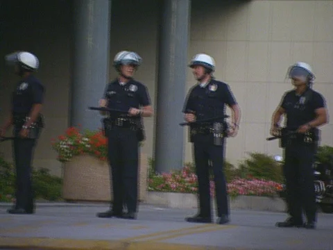LA Riots Parker Center Protesters in picket line walking in front of news van Stock Footage 75286505