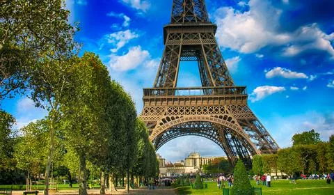 La Tour Eiffel, Paris. Tower sunset view with Champs de Mars gardens Stock Photos
