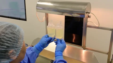 A lab assistant in a blue coat checks the medicament Stock Footage 125605587