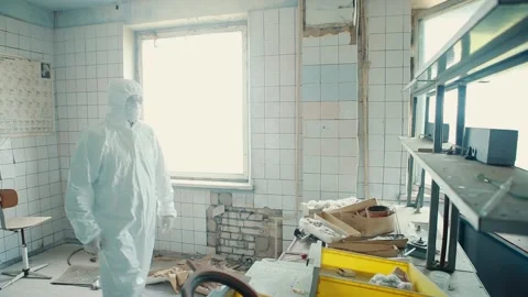 The lab assistant is in the exclusion zone, comes to a table in an abandoned Stock Footage 131515992