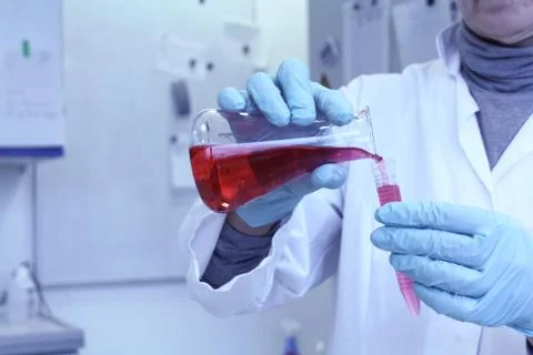 Lab assistant forgets red liquid from test tube Stock Photos