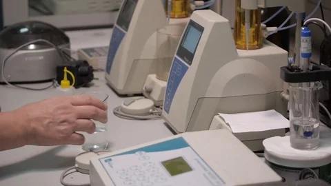 The lab assistant puts the flask on the laboratory cintrifuge Stock Footage 75388487