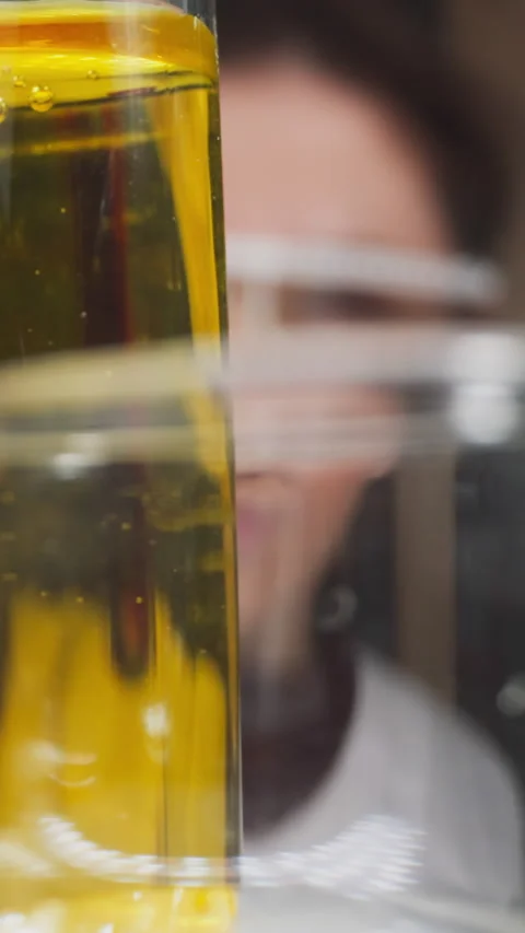 Lab assistant puts test tube with red liquid sample on rack Stock Footage 310865751