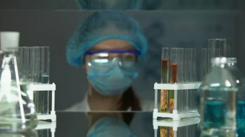 Lab assistant studying meat sample with magnifying glass, helminth analysis Stock Footage 104993119