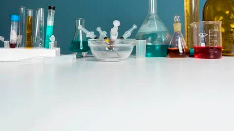 Lab desk. Test tubes small and big a white background. Copy Space. Stock Photos