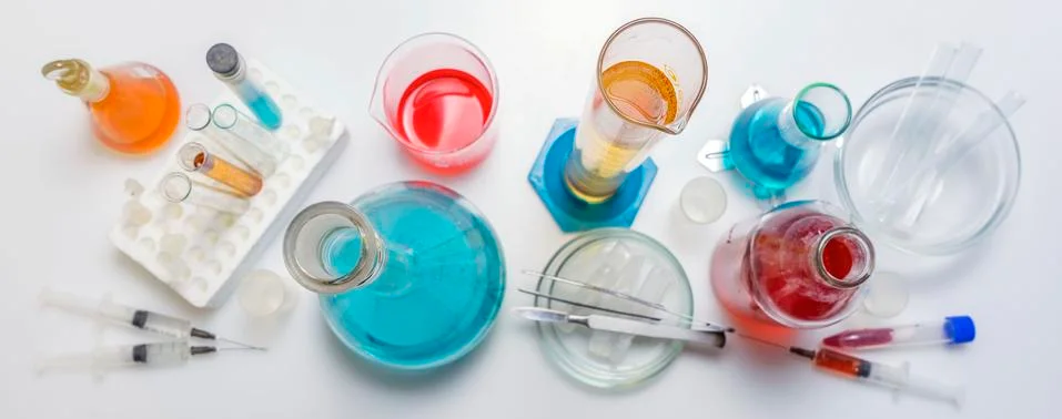Lab desk. Test tubes small and big a white background. Top view. Stock Photos