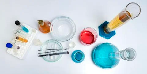 Lab desk. Test tubes small and big a white background. Top view. Stock Photos