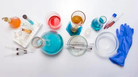 Lab desk. Test tubes small and big a white background. Top view. Stock Photos