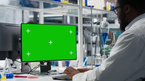Lab engineer at desk typing on isolated screen PC keyboard Stock Footage 320144076