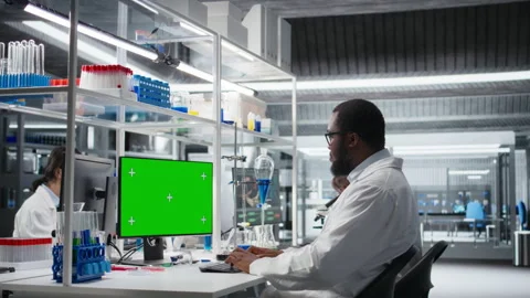 Lab engineer at desk typing on isolated screen PC keyboard Stock Footage 320146701