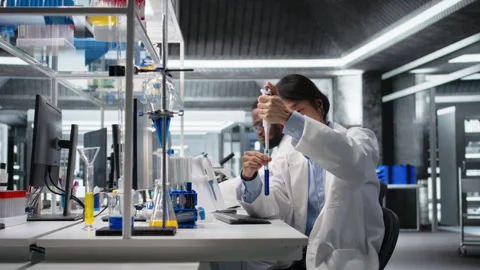Lab engineer does pipetting procedure with chemical reagent, mixing solutions Stock Footage 320147227