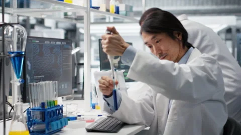 Lab engineer does pipetting procedure with chemical reagent, mixing solutions Stock Footage 320739579