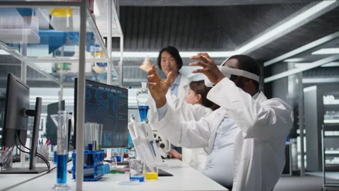 Lab engineer at PC desk using VR goggles to look at molecular model, rotating it Stock Footage 320147366