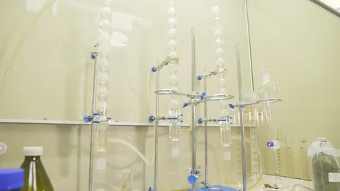Lab flasks and measuring cups in medical laboratory. Panning shot of flasks with Stock Footage 111209480