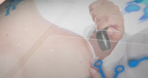 Lab hand entering with scanner initiating scan on patient shoulder moving down Stock Footage 318626374