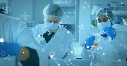 Lab pair lifting flask, testing via pipette at microscope molecular overlay Stock Footage 331272746