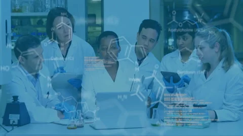 Lab researchers operating laptop while discussing findings and animated chemical Stock Footage 310282714