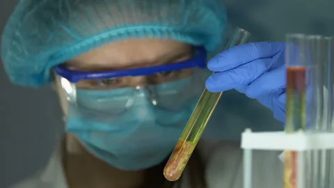 Lab scientist adding chemical agent to meat sample in tube, gmo food expertise Stock Footage 104944652