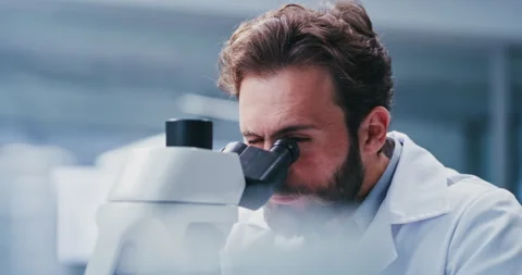 Lab, scientist and man with microscope, healthcare or cell analysis for vaccine Stock Footage 329864168