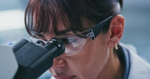 Lab, scientist and woman with microscope, glasses and exam for vaccine, analysis Stock Footage 330082121