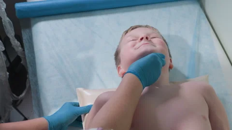 Lab Scientist Helps Smiling Boy Relax with Pillow During Medical Procedure Stock-Footage 306033780