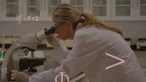 Lab scientist peering into microscope and adjusting knobs while math notes Video stock 322706547