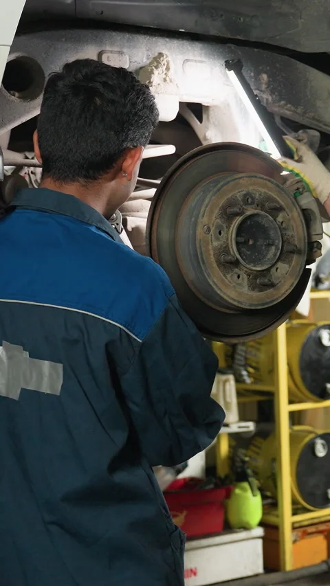 Lab Scientists Observing Mechanic and Taking Notes in Automotive Workshop Stock Footage 318261342