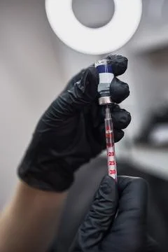In lab setting, precise dosage preparation filling syringe with medicine usin Stock Photos