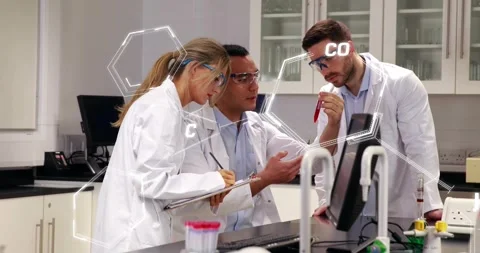 Lab team clustering right holding test tube near screen causing hex flagging Stock Footage 330621886