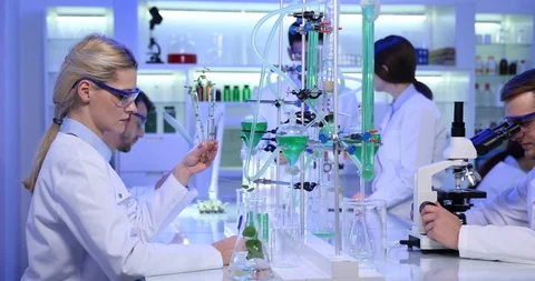Lab Team of People Scientists Working with Microscope in Chemistry Laboratory Stock Footage 85565009