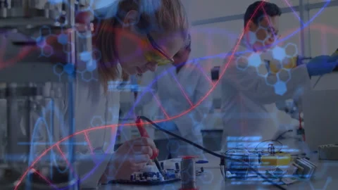 Lab team starting soldering board while testing voltage, linking electronics to Stock Footage 312916036