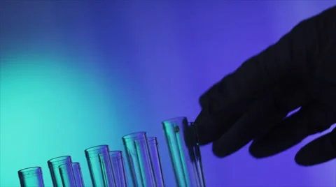Lab tech adding to test tube Stock Footage 1180724
