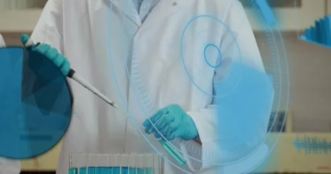 Lab tech bringing pipette forward, drawing blue and filling tube rack for assay Stock Footage 331272735