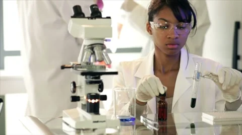 Lab tech comparing two liquids Stock Footage 8833064