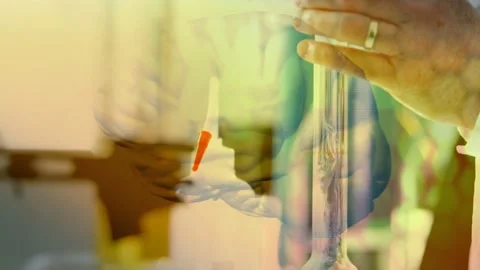 Lab tech holding flask adding drops with dropper testing reaction as brain Stock Footage 335651795